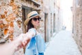 Man follow his girlfriend holding hands in old european street laughing and smiling Royalty Free Stock Photo