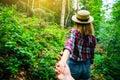 Follow me photo in the mountains. Stylish woman in checkered shirt and straw hat. Wanderlust concept. Couple hiking and travelling Royalty Free Stock Photo