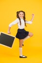 Follow me. Schoolgirl pupil informing. School girl hold blank chalkboard copy space. Announcement and promotion. Girl