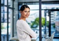 Follow me to my office. Cropped portrait of an attractive young businesswoman smiling while standing with her arms Royalty Free Stock Photo