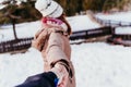 follow me. woman and man holding hands. pov. winter season at the mountain. Love concept