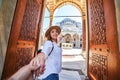 Follow me. A woman tourist in a hat leads her friend to the Turkish mosque Suleymaniye, Istanbul, Turkey. Travel and religion Royalty Free Stock Photo