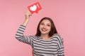 Follow my blog and click Like! Portrait of happy blogger woman in striped sweatshirt holding social media Heart button