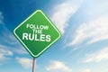 Follow the rules road sign with blue sky and cloud background Royalty Free Stock Photo