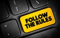 Follow The Rules text button on keyboard, concept background Royalty Free Stock Photo
