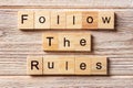 Follow The Rules word written on wood block. Follow The Rules text on table, concept Royalty Free Stock Photo