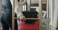 Follow shot of bellman pushing baggage cart along hotel corridor