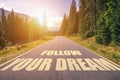 Follow your dream text written on road in the mountains Royalty Free Stock Photo