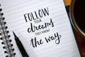 FOLLOW YOUR DREAMS THEY KNOW THE WAY hand-lettered in notebook Royalty Free Stock Photo