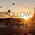 Follow your dreams quote concept with beautiful sunset on bike road with ballons and hills in the background