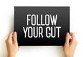 Follow Your Gut text on card, concept background Royalty Free Stock Photo