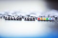 Follow your heart text spelled with plastic letter beads