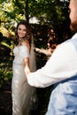 Follow your loved one. newlywed to hold hands. Bride and groom walk in park