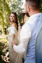 follow your loved one. newlywed to hold hands. Bride and groom walk in park