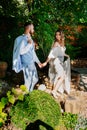 Follow your loved one. newlywed to hold hands. Bride and groom walk in park