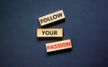 Follow your passion symbol. Concept words Follow your passion on blocks on beautiful black table black background. Business, Royalty Free Stock Photo