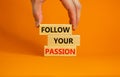 Follow your passion symbol. Concept words Follow your passion on blocks on beautiful orange table orange background. Business, Royalty Free Stock Photo