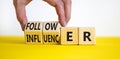 Follower or influencer symbol. Concept words Follower Influencer on wooden cubes. Beautiful yellow table white background.