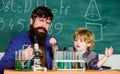 Following father in everything. My father is scientist. Teacher bearded man father and child test tubes. Study chemistry