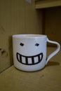 a smiling coffee cup on the table