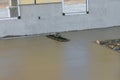 Following pouring of concrete worker plasters a wet concrete cement floor with a trowel Royalty Free Stock Photo