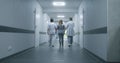 Following shot of doctors walking along the clinic hallway Royalty Free Stock Photo