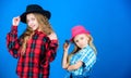 Following sister in everything. Girls kids wear fashionable hats. Small fashionista. Cool cutie fashionable outfit Royalty Free Stock Photo