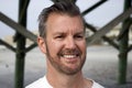 Folly Beach South Carolina, February 17, 2018 - head shot of white male with short trimmed beard and combed back hair with head sl