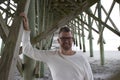 Folly Beach South Carolina, February 17, 2018 - Man in longsleeved white shirt standing under beach pier