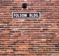 Folson BLDG Red Brick Wall with Black and White Sign Royalty Free Stock Photo