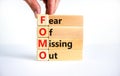 FOMO fear of missing out symbol. Concept words FOMO fear of missing out on blocks on a beautiful white background. Copy space. Royalty Free Stock Photo