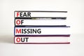 FOMO fear of missing out symbol. Concept words FOMO fear of missing out on books on a beautiful white background. Copy space. Royalty Free Stock Photo