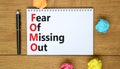FOMO fear of missing out symbol. Concept words FOMO fear of missing out on the note on a beautiful white background. Business FOMO Royalty Free Stock Photo