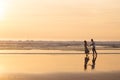 Fond couple walking on beach at sunset Royalty Free Stock Photo