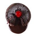 Fondant chocolate cake with cherry closeup isolated on white