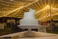 Fondant wedding cake over table with sword at banquet hall Royalty Free Stock Photo