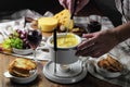 Fondue with croutons,wine and grapes