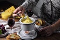 Fondue with croutons,wine and grapes