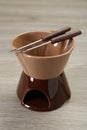 Fondue set on wooden table, closeup. Kitchen equipment Royalty Free Stock Photo