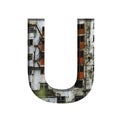 Font on an abandoned industrial building. The letter U cut out of paper on a background of windows and doors of an abandoned