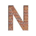 Font on brick texture. Letter N, cut out of paper on a background of real brick wall. Volumetric white fonts set
