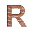 Font on brick texture. Letter R, cut out of paper on a background of real brick wall. Volumetric white fonts set