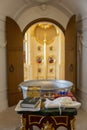 A font with water for the baptism of children in the Orthodox Church against the background of the altar. Close-up. Vertical