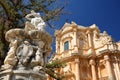 Fontana d\'Ercole (Fountain of Hercules, dating from 1757) with San Domenico church in the background Royalty Free Stock Photo