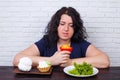 Food addiction, dieting concept. Young overweight woman fighting Royalty Free Stock Photo