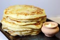 Food. Appetizing baked thick yeast pancakes are stacked on a plate on the table. Royalty Free Stock Photo