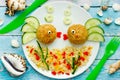 Food art idea healthy lunch for kids meatballs with bulgur porridge and fresh vegetables shaped cute fishes