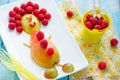 Food art idea for kids - pear and raspberry funny man Royalty Free Stock Photo