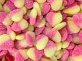 Appetizing pink-yellow jelly candies in the form of hearts close