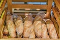 Food background baguettes on a wooden shelf in a store, bread close-up Royalty Free Stock Photo